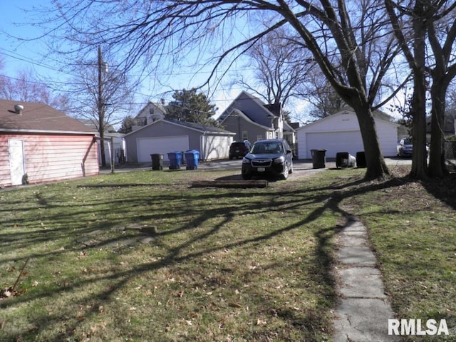 view of yard with an outdoor structure and a garage