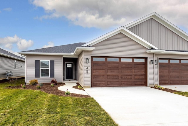 view of front of property with a garage and a front lawn