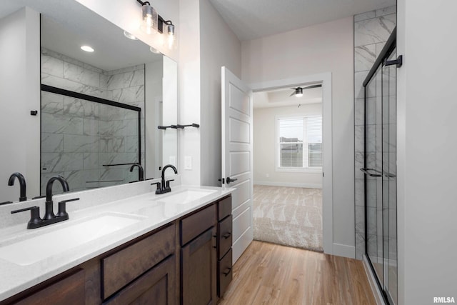 bathroom featuring vanity, a shower with shower door, and hardwood / wood-style flooring