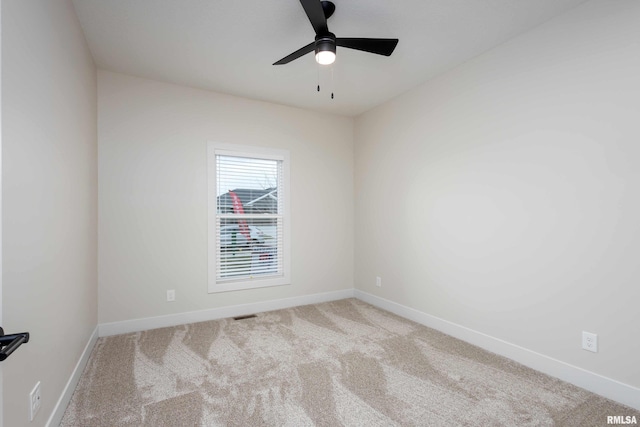 carpeted empty room featuring ceiling fan