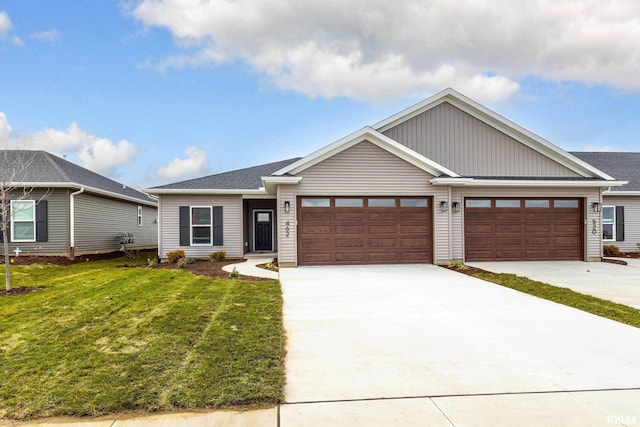 view of front of property featuring a front yard and a garage