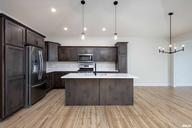 kitchen featuring sink, light hardwood / wood-style flooring, pendant lighting, and appliances with stainless steel finishes