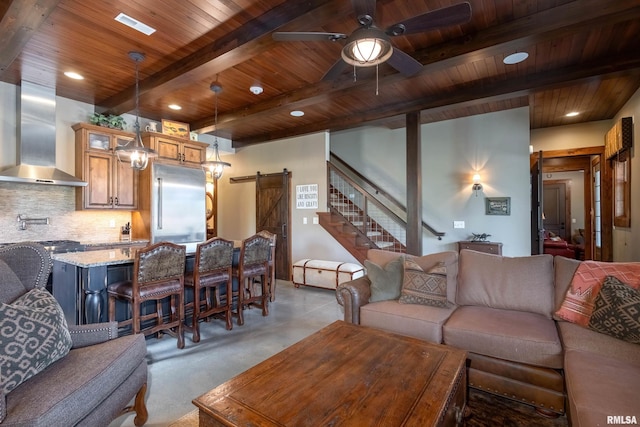 carpeted living room featuring a barn door, ceiling fan, beamed ceiling, and wood ceiling