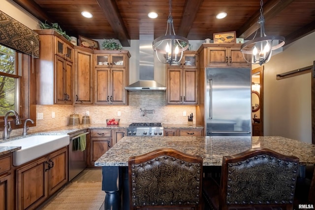 kitchen with appliances with stainless steel finishes, glass insert cabinets, and a center island