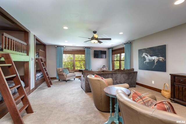 carpeted living room with a healthy amount of sunlight and ceiling fan