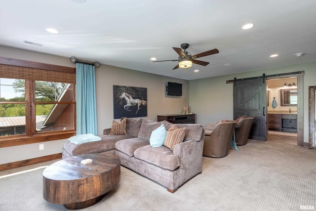 living room with recessed lighting, a barn door, carpet flooring, ceiling fan, and baseboards