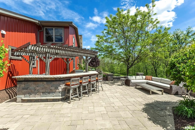 view of patio with a pergola, an outdoor hangout area, and a bar