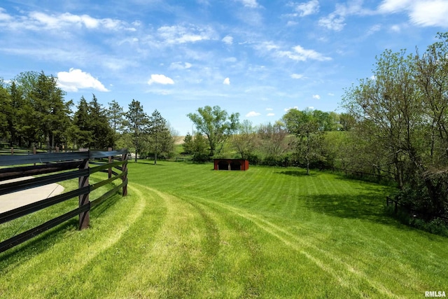 view of yard with fence and an outdoor structure