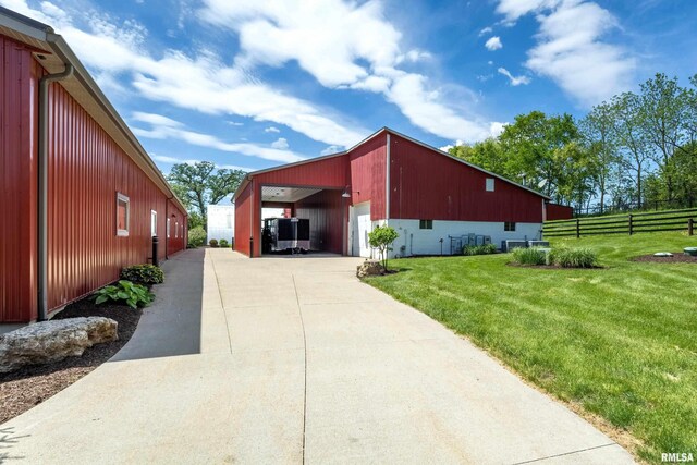 view of home's exterior featuring a carport and a yard