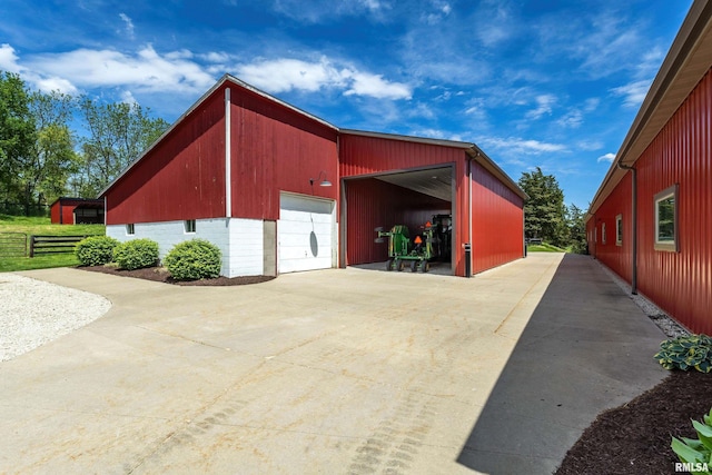 detached garage featuring fence