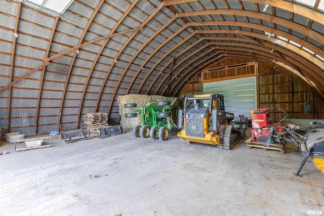 interior space featuring lofted ceiling and concrete floors