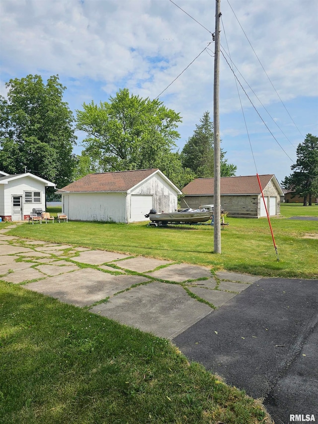 view of yard with a garage and an outdoor structure