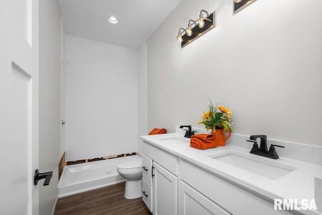 bathroom featuring vanity, toilet, and hardwood / wood-style floors