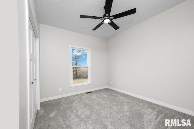 unfurnished room featuring carpet flooring and a textured ceiling