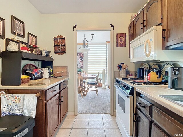 kitchen featuring white appliances and light tile patterned floors