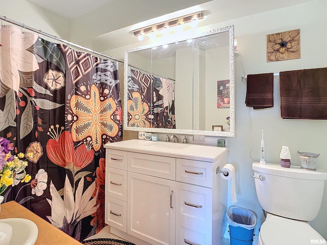 bathroom with tile patterned floors, vanity, and toilet