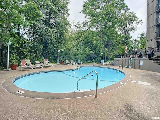 view of swimming pool with a patio area