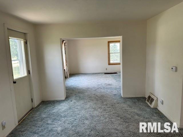 carpeted empty room with a healthy amount of sunlight