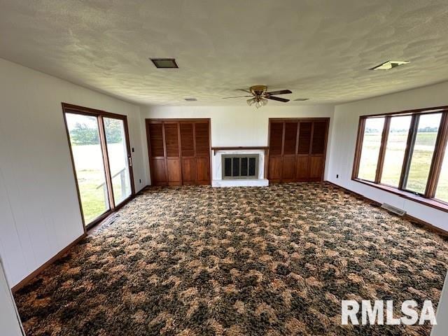 unfurnished living room with carpet flooring and ceiling fan