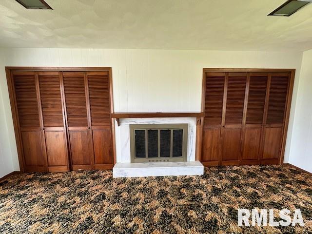 unfurnished living room featuring carpet flooring