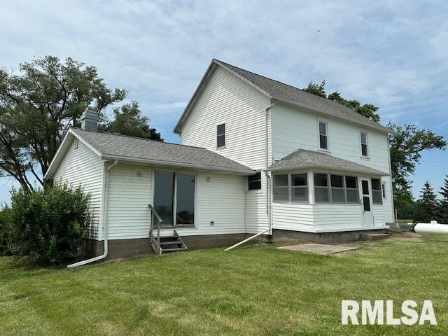 back of house featuring a sunroom and a yard