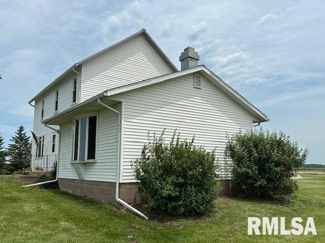 view of side of property with a lawn