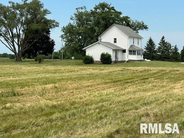 view of side of home featuring a yard