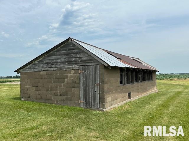 view of outdoor structure featuring a lawn