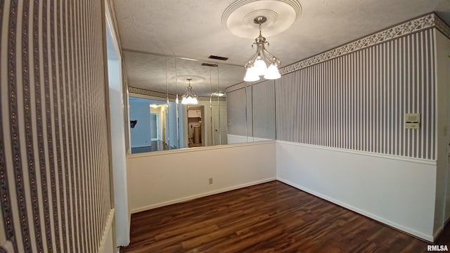 empty room featuring hardwood / wood-style flooring and a textured ceiling