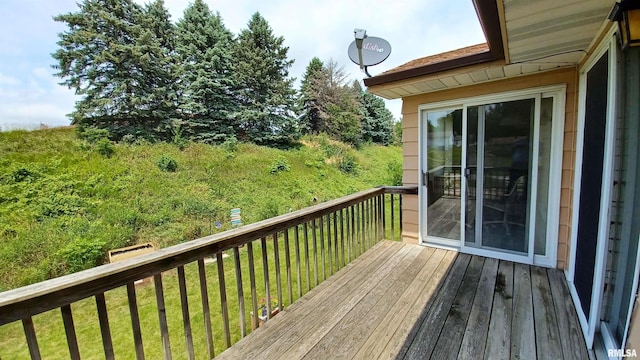 wooden deck featuring a yard