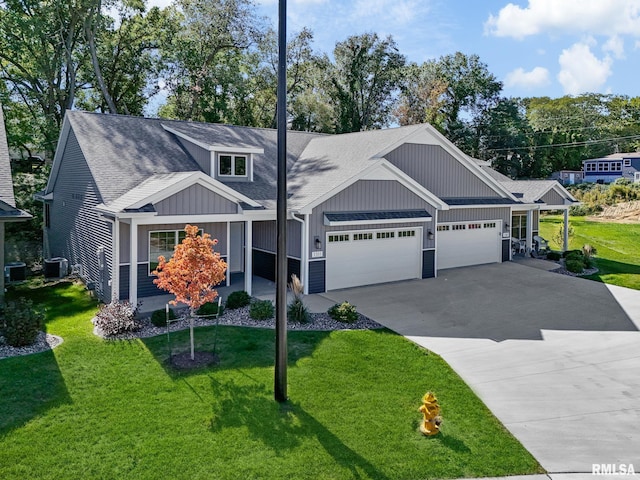 craftsman inspired home featuring central AC, a front yard, and a garage