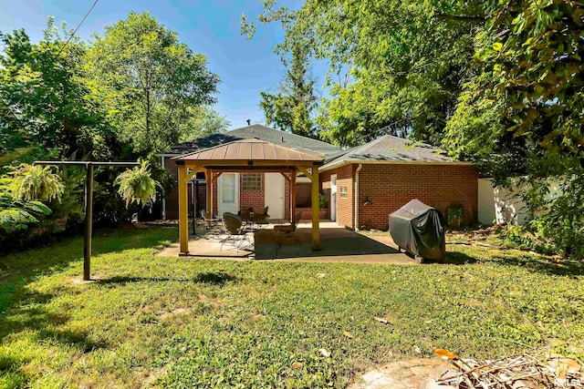 rear view of house with a lawn, a patio area, and a gazebo