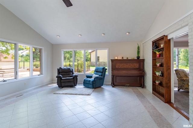 living area featuring plenty of natural light, light tile patterned floors, and high vaulted ceiling