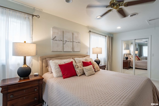 carpeted bedroom featuring ceiling fan and a closet