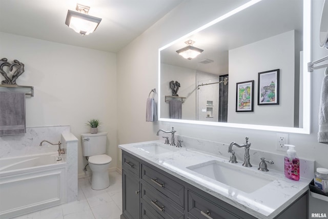 bathroom with vanity, a tub, and toilet