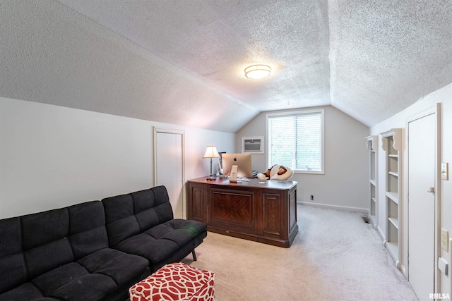 office area featuring lofted ceiling, light carpet, and a textured ceiling