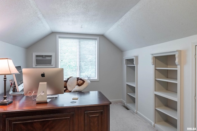 carpeted office space featuring lofted ceiling, a wall mounted air conditioner, and a textured ceiling