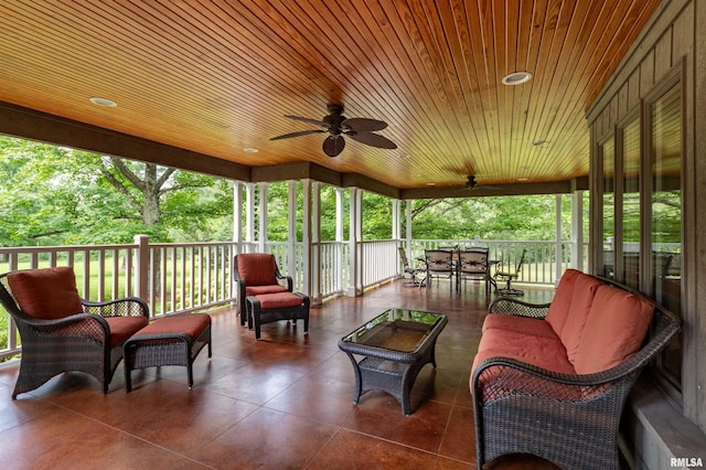 sunroom with ceiling fan, a wealth of natural light, and wood ceiling