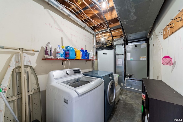 laundry room featuring heating unit and washer and dryer