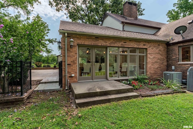 rear view of house with french doors, a lawn, a patio area, and central air condition unit