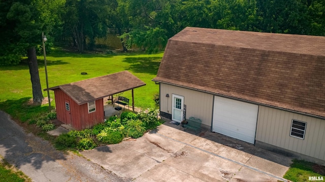 exterior space featuring a garage and a lawn