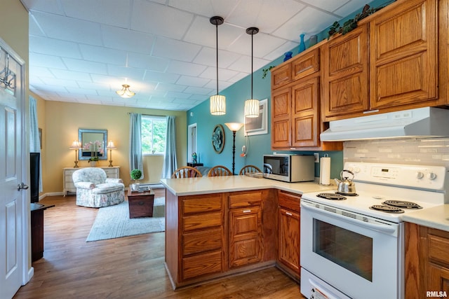 kitchen featuring decorative light fixtures, a baseboard heating unit, electric range, light hardwood / wood-style floors, and kitchen peninsula