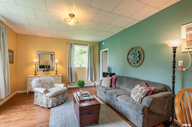 living room with a baseboard radiator and light hardwood / wood-style floors