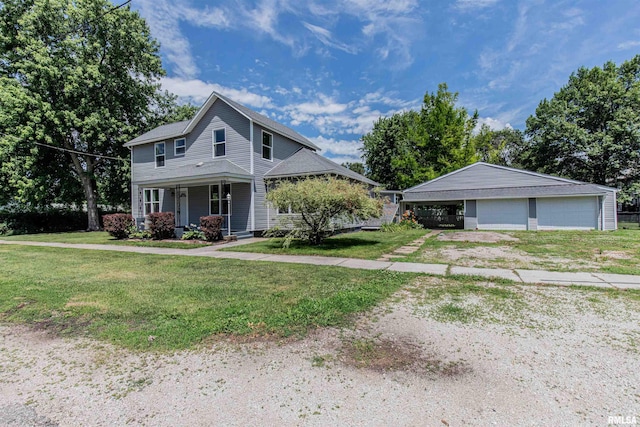 view of front of house with a porch, a garage, a front lawn, and an outdoor structure