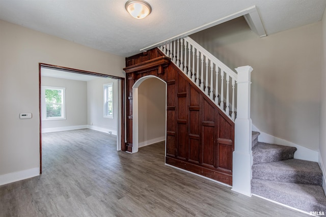 stairway featuring wood-type flooring