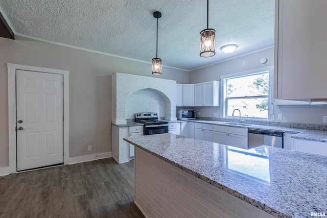 kitchen featuring sink, hanging light fixtures, light stone countertops, appliances with stainless steel finishes, and white cabinetry