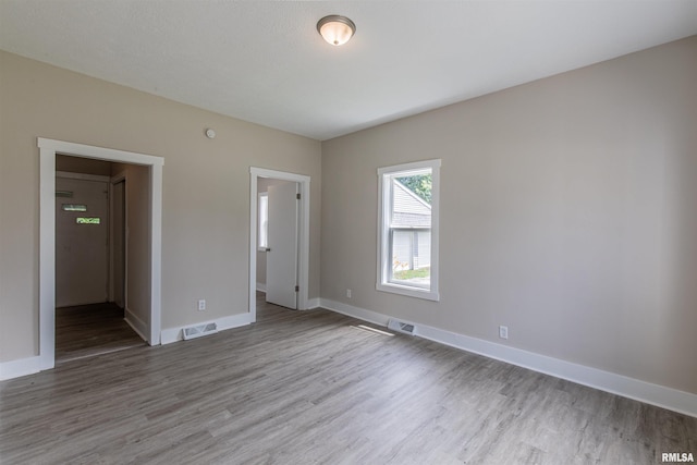 unfurnished bedroom with hardwood / wood-style floors