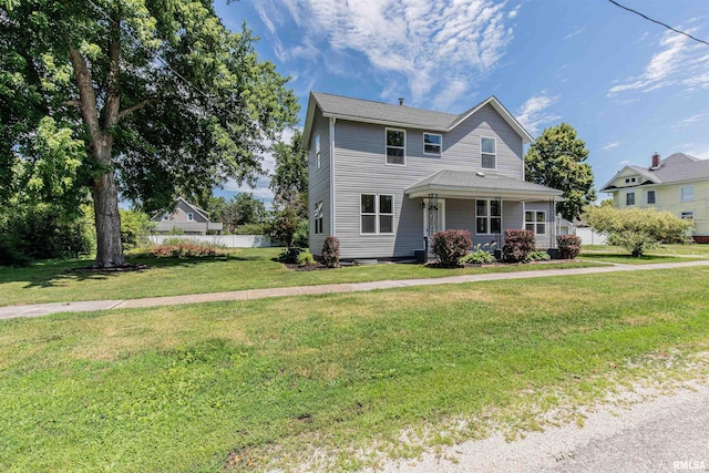 view of front facade with a front lawn and covered porch