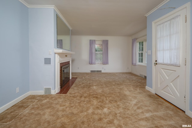 unfurnished living room featuring crown molding, a fireplace, and light carpet