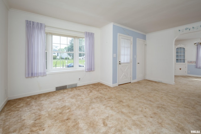 unfurnished room with ornamental molding and light carpet